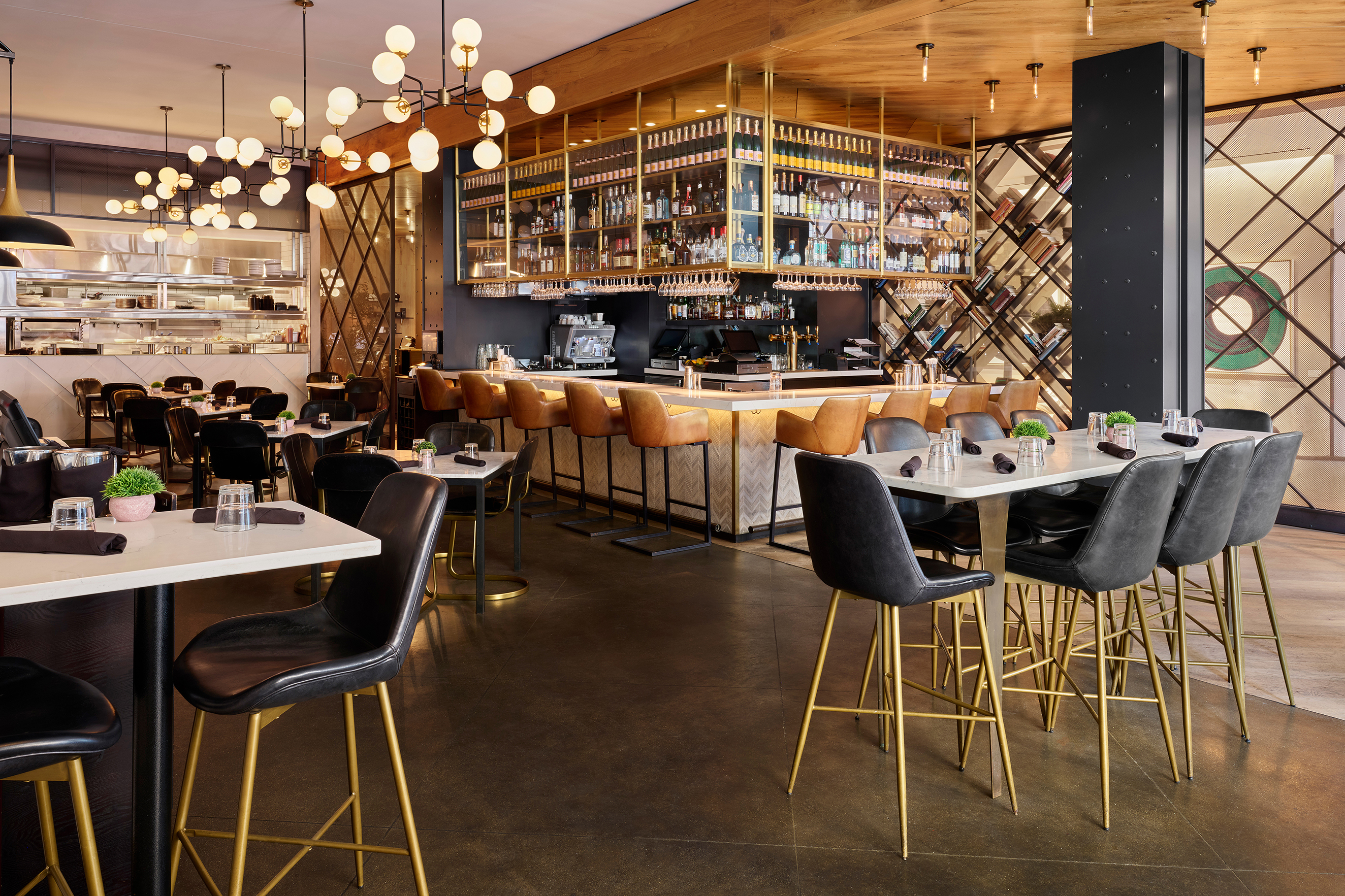 a dining area with a bar and tables