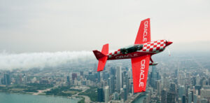 Oracle stunt plane performing over the Chicago skyline during the Chicago Air and Water Show along Lake Michigan.