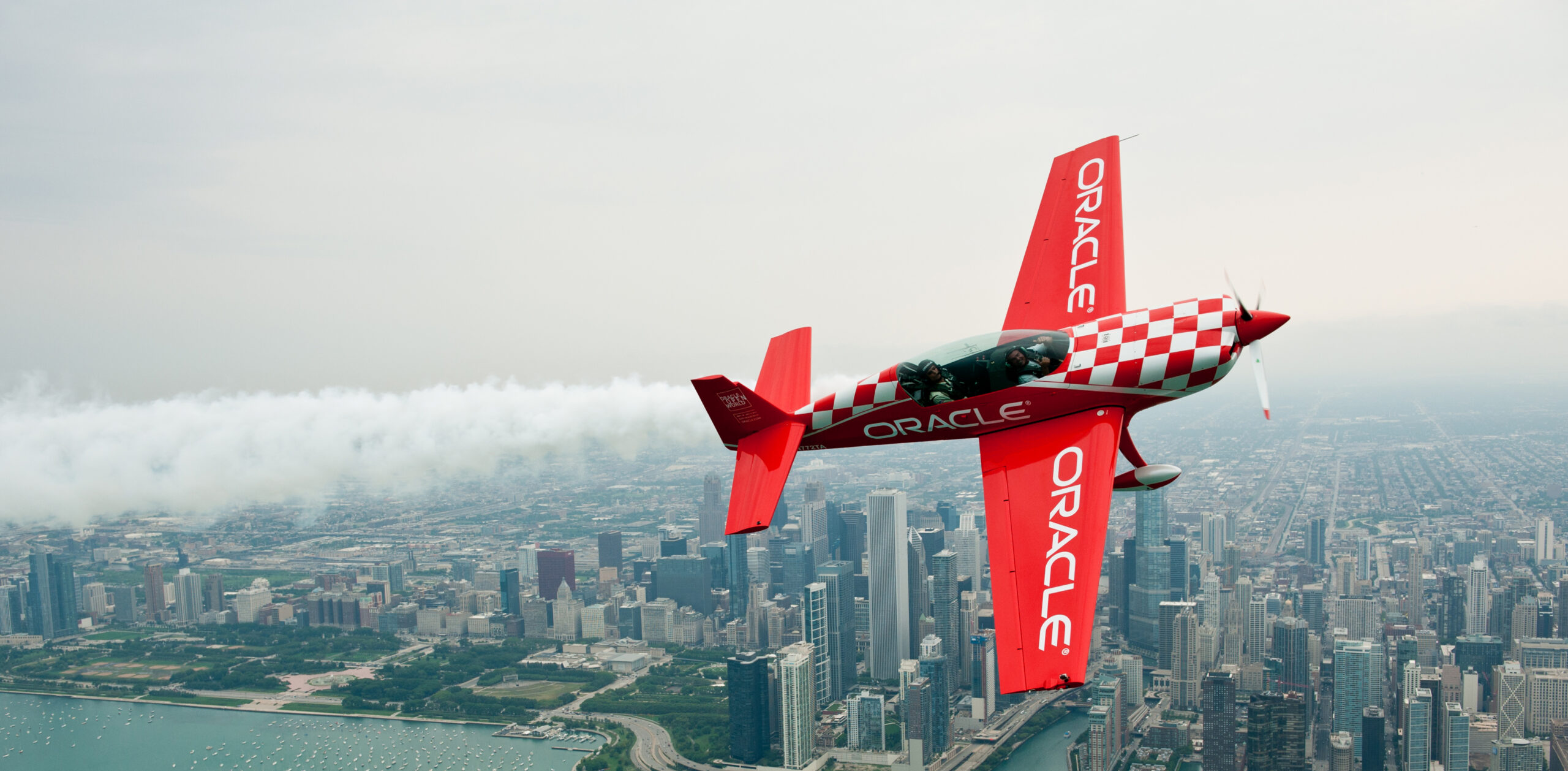 Oracle stunt plane performing over the Chicago skyline during the Chicago Air and Water Show along Lake Michigan.