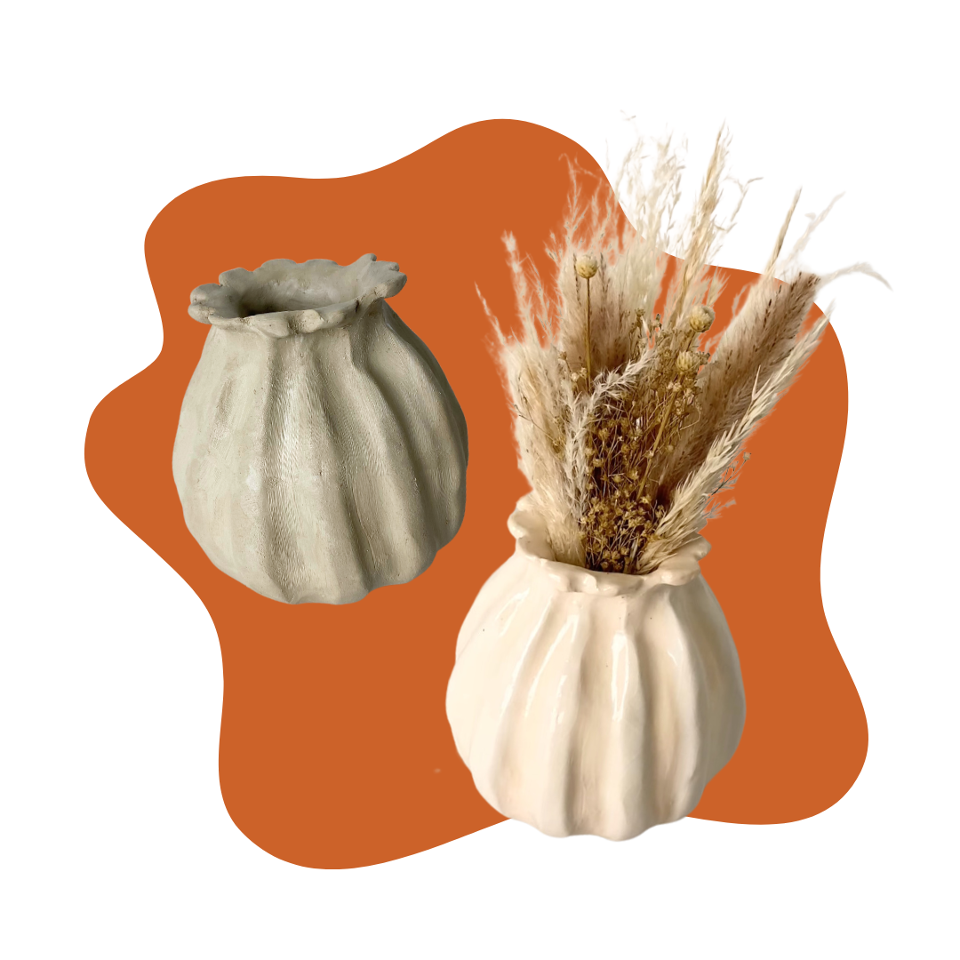 Two scalloped ceramic vases, one empty and one filled with dried flowers, displayed against an orange, irregularly shaped backdrop.