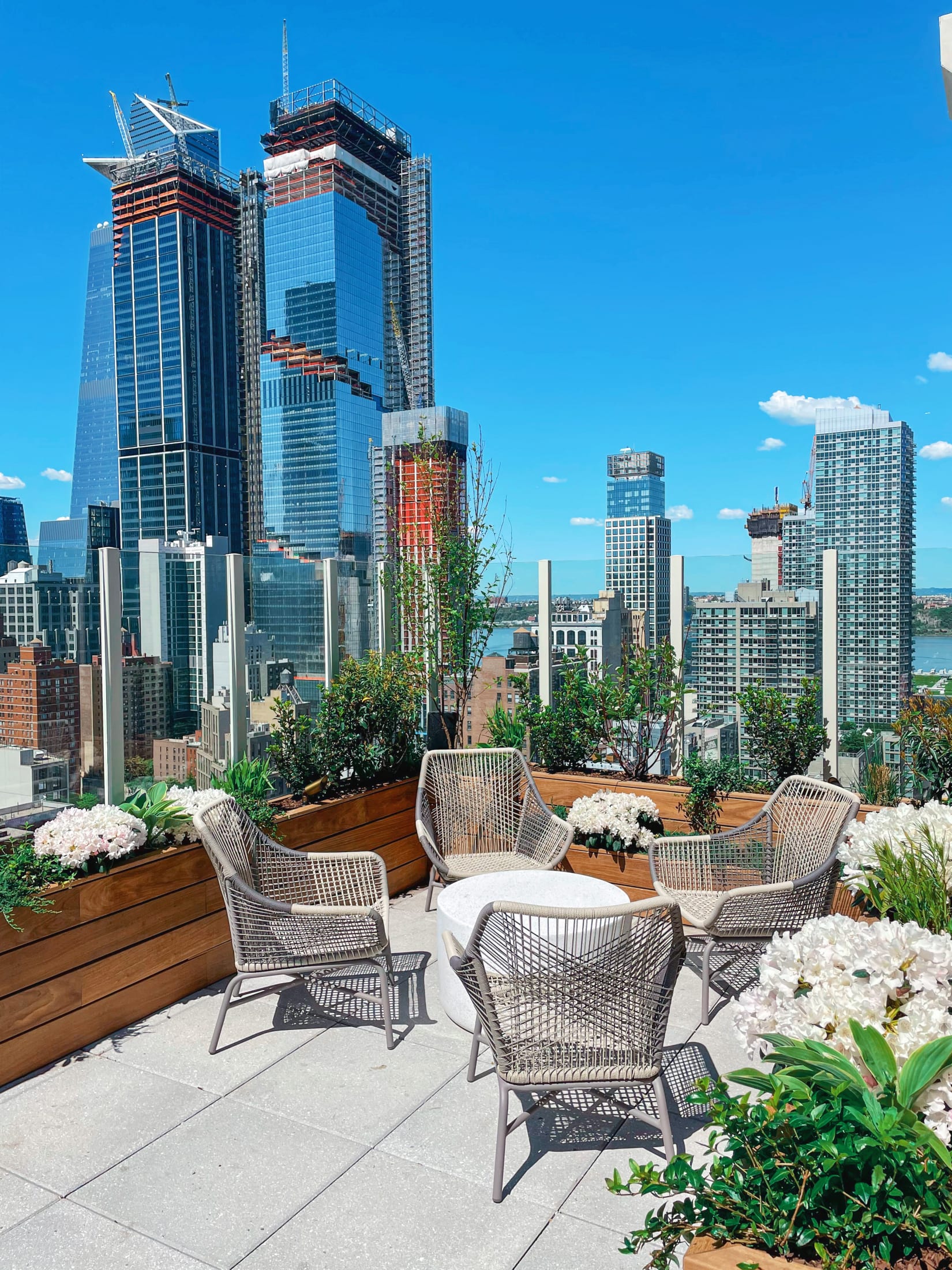 Arlo Midtown outdoor lounge space with New York City skyline in background
