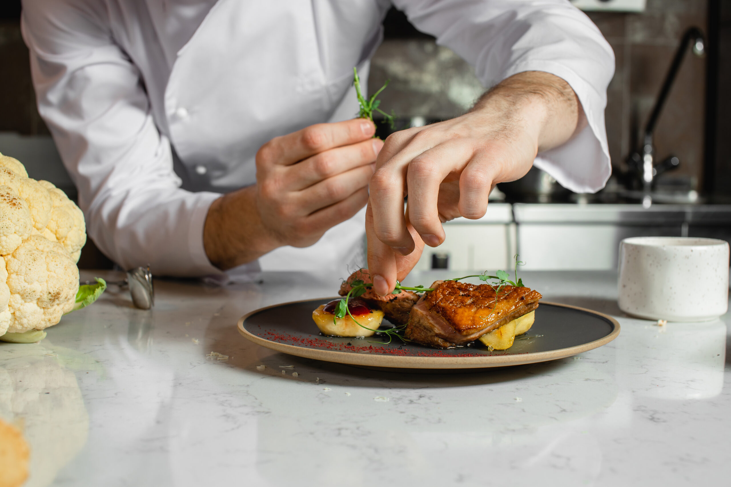 A professional chef preparing a delectable dish at an nyc restaurant