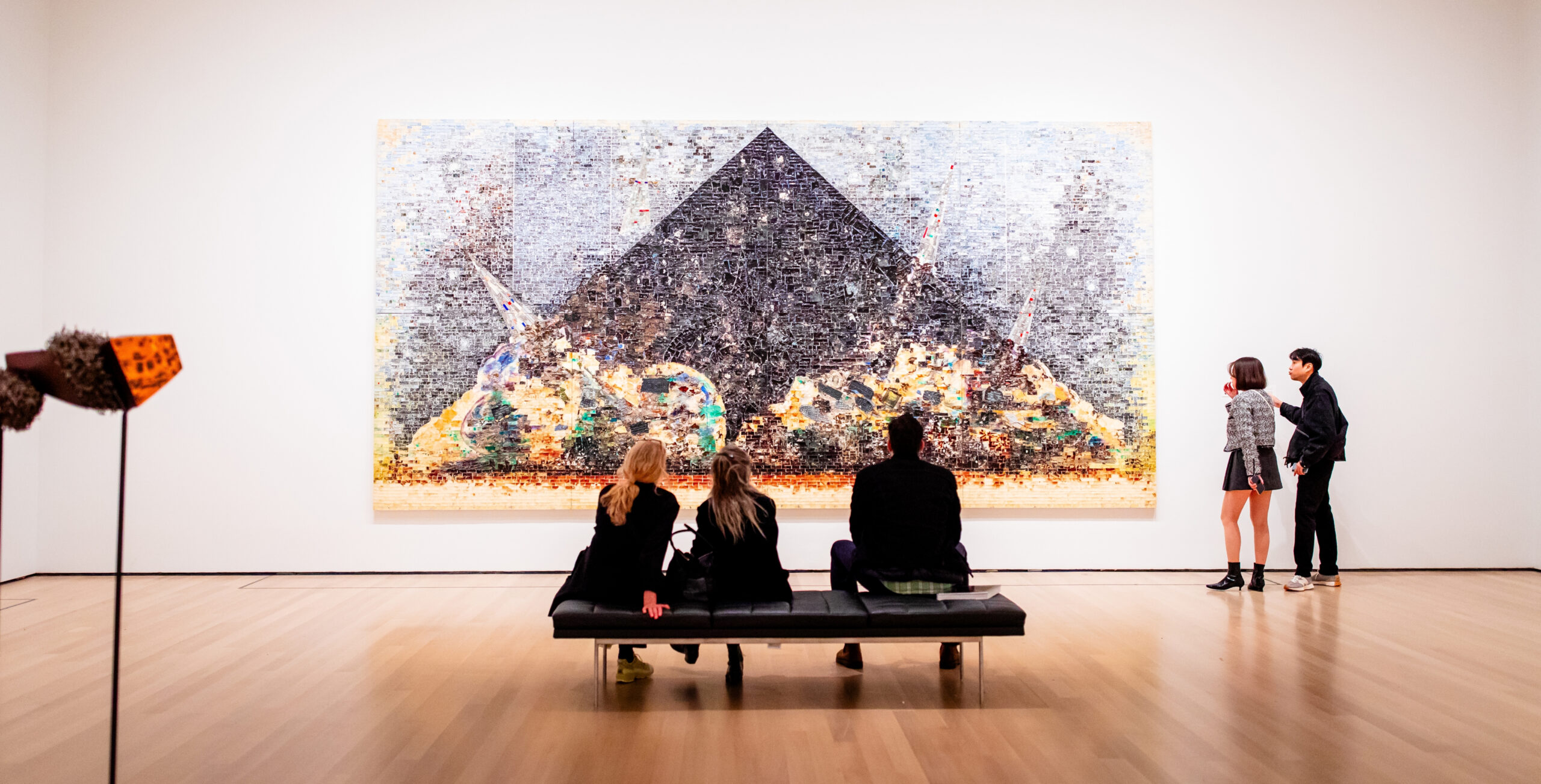 minimalist art gallery featuring a massive, intricate mosaic on the far white wall in an nyc museum