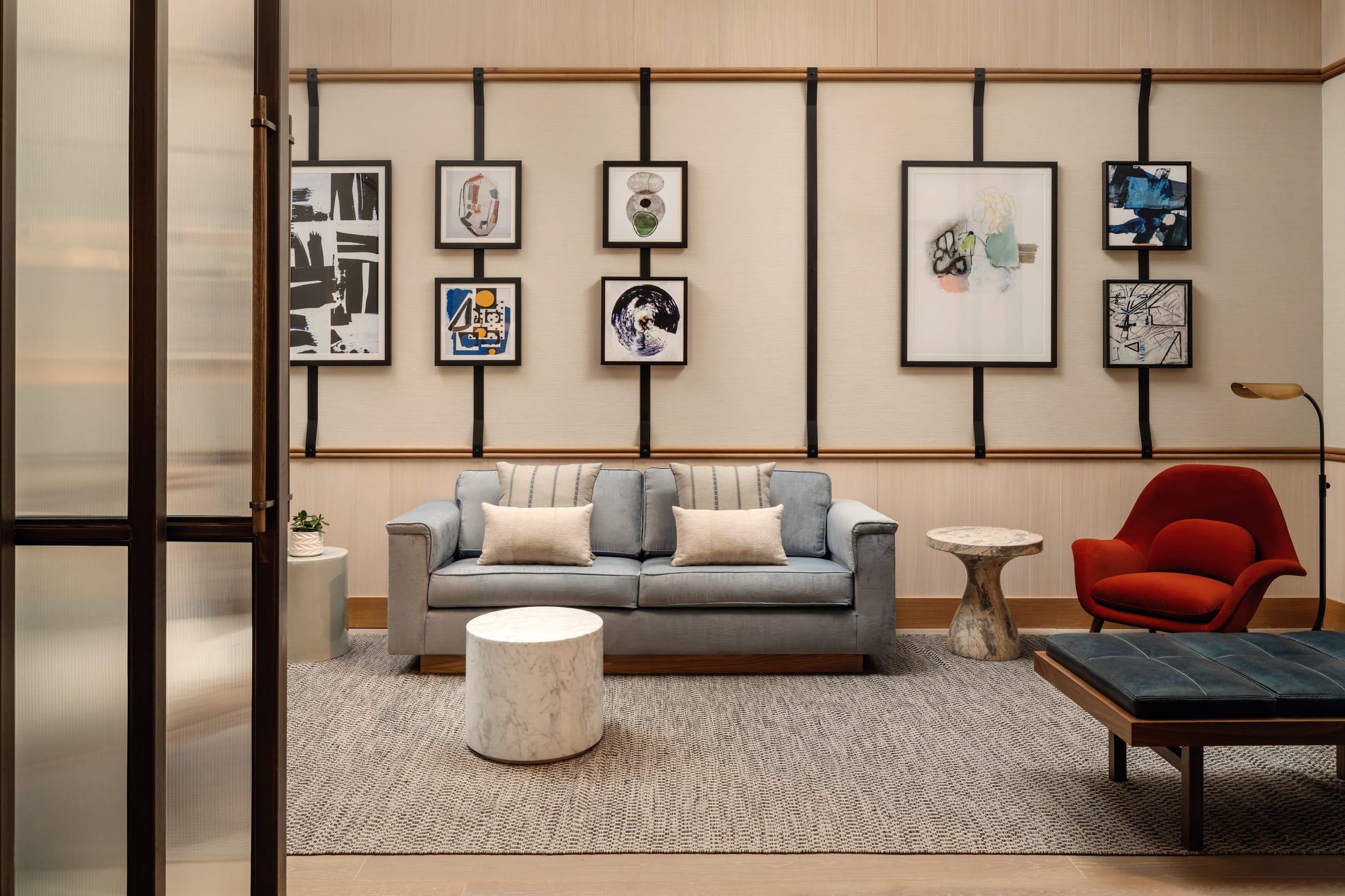 Modern hotel alcove lounge at Arlo Hotels featuring contemporary artwork, minimalist furniture, and a cozy seating area with soft neutral tones and modern design accents.