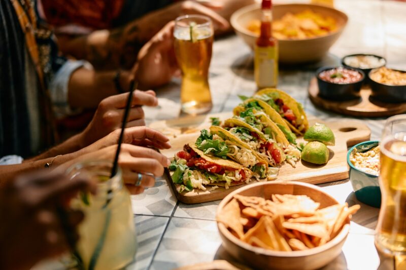 Tacos, fries, and drinks served at a restaurant table during a casual Midtown Manhattan lunch.