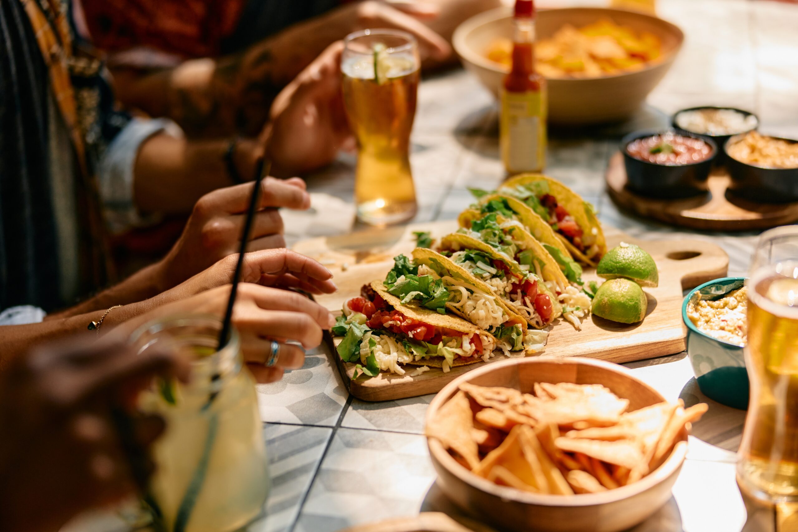 Tacos, fries, and drinks served at a restaurant table during a casual Midtown Manhattan lunch.