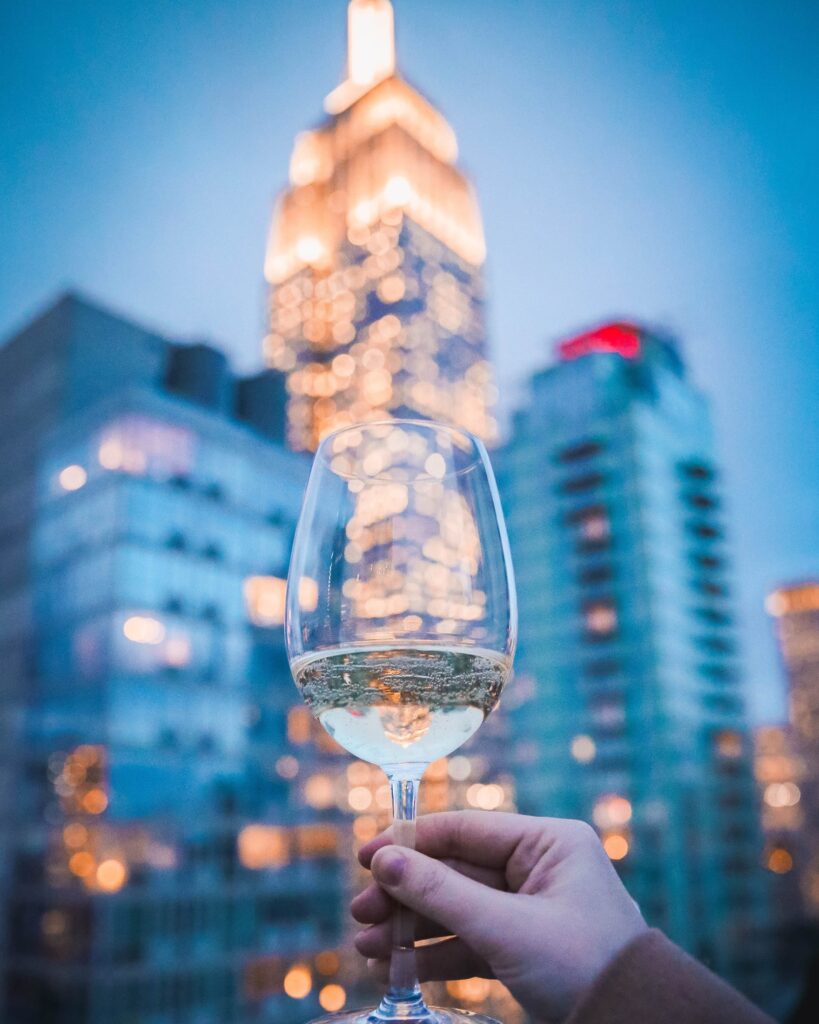 Glass of wine with New York City skyline in background