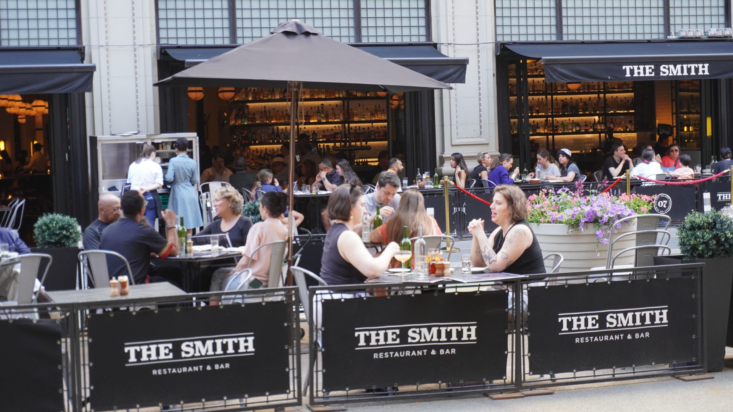 the outdoor patio of The Smith Restaurant & Bar, a lively urban eatery.