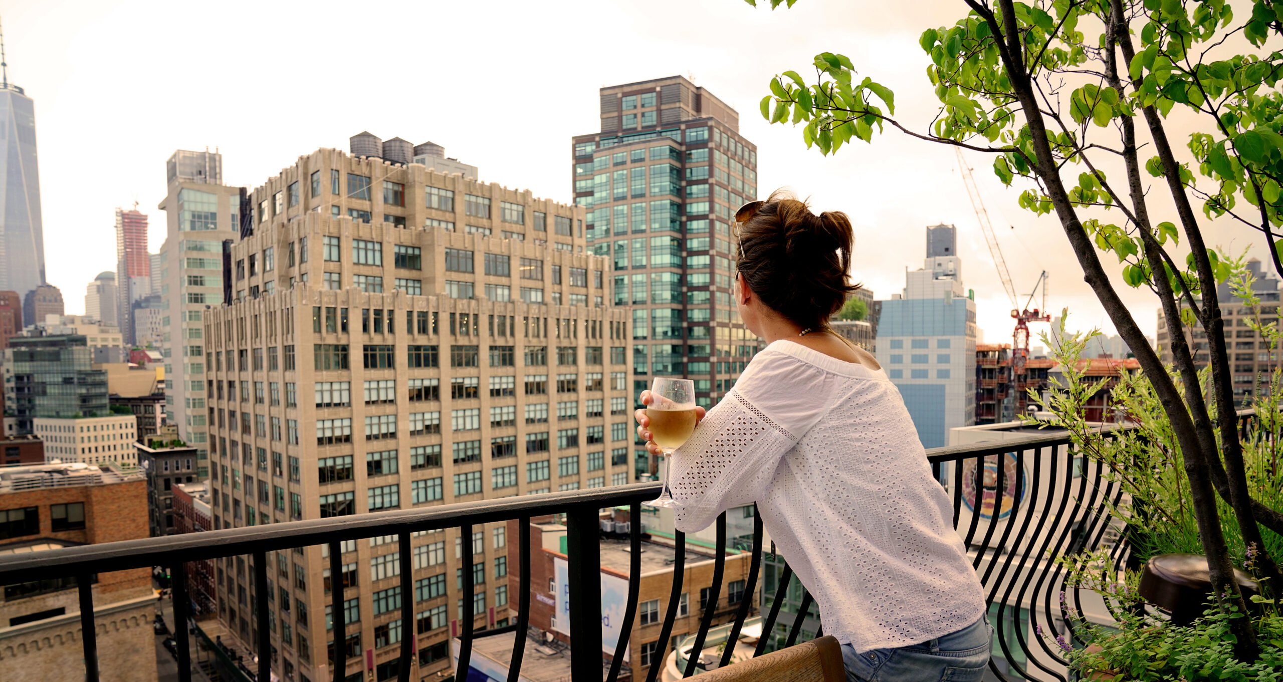 Woman relaxing on one of the rooftop cafes on NYC in March.