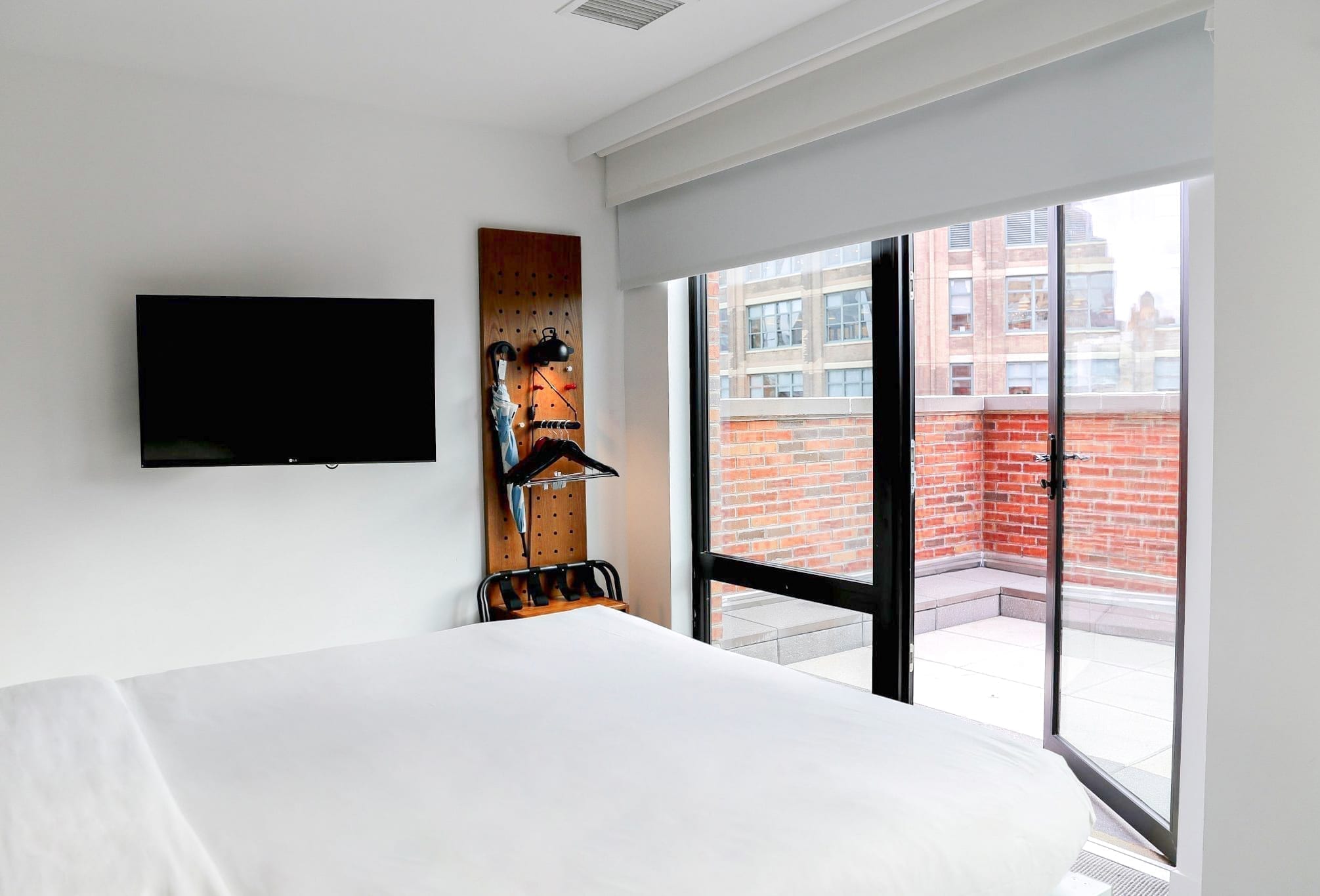 Arlo SoHo Accessible City Queen hotel room bed and outdoor terrace