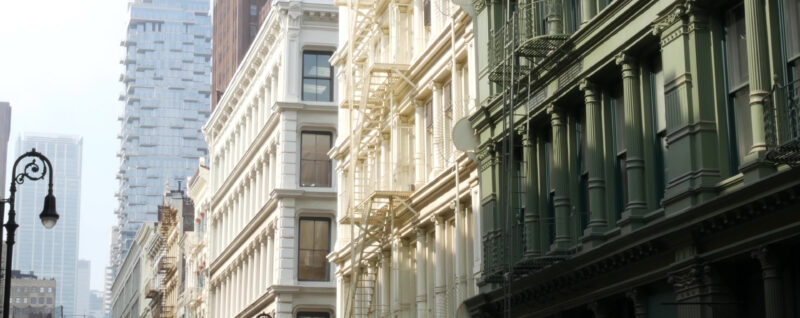 Classic cast-iron architecture and modern city buildings in SoHo, showcasing one of the top SoHo NYC attractions in Lower Manhattan.