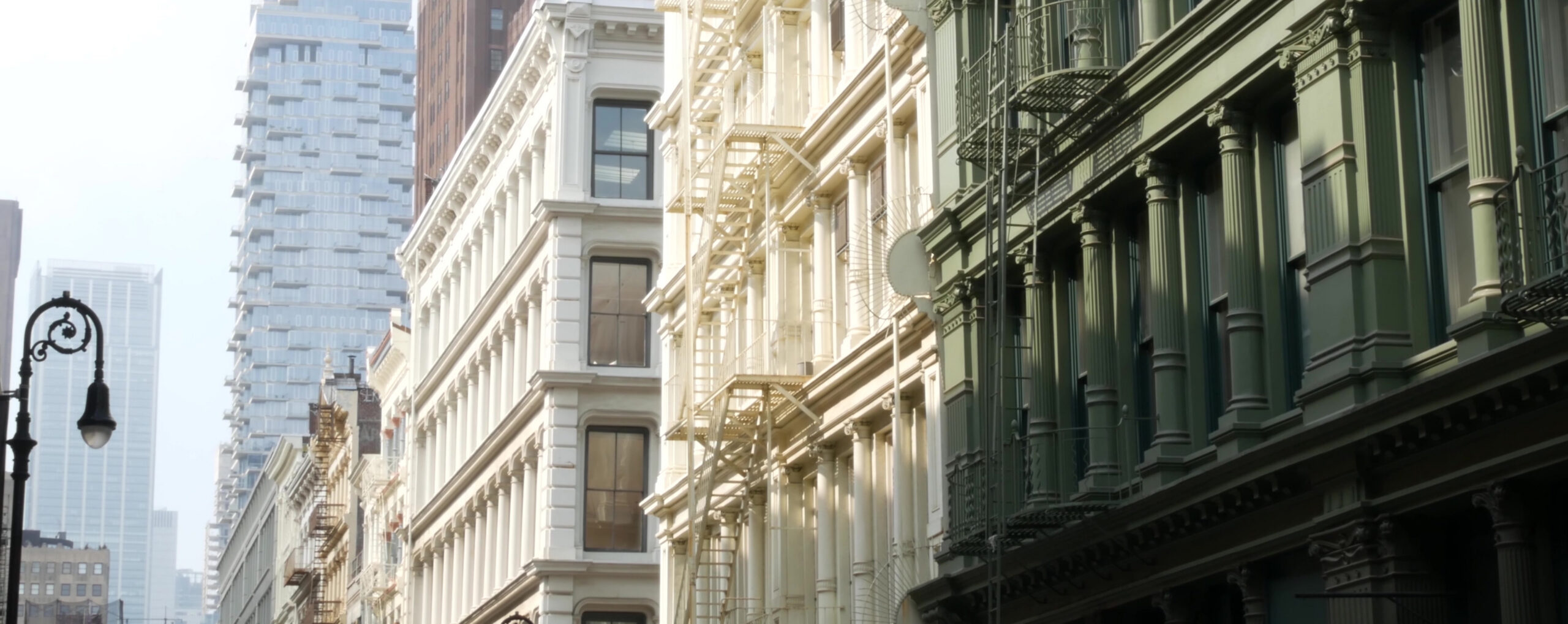 Classic cast-iron architecture and modern city buildings in SoHo, showcasing one of the top SoHo NYC attractions in Lower Manhattan.