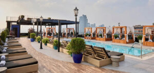 ART Williamsburg rooftop with pool, lounge seating, and cabanas overlooking the Brooklyn skyline