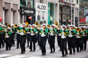 A marching band performs during the Labor Day Parade along a downtown street in New York City.