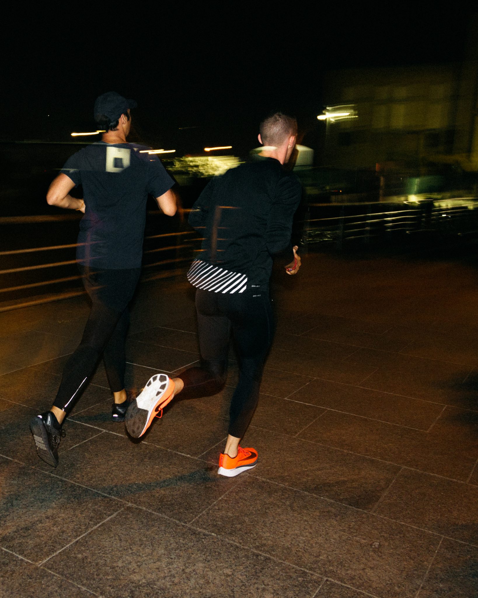 Blurred runners on a bridge