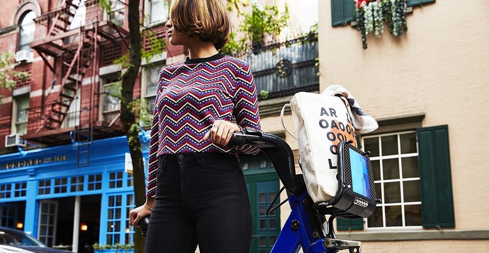 Woman with reusable bag on bike