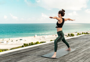 woman doing yoga at the Ocean Terrace of Nautilus on Miami Beach