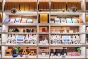 Shelves in NYC Arlo SoHo full of different products such as books and candles