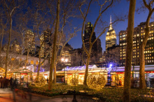outdoor holiday market all lit up in NYC near Empire State Building