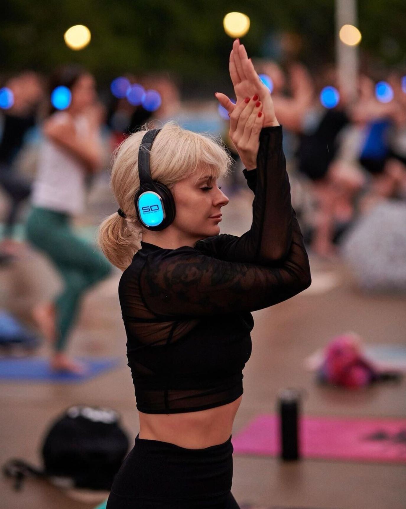 Woman in a yoga pose during a silent disco event