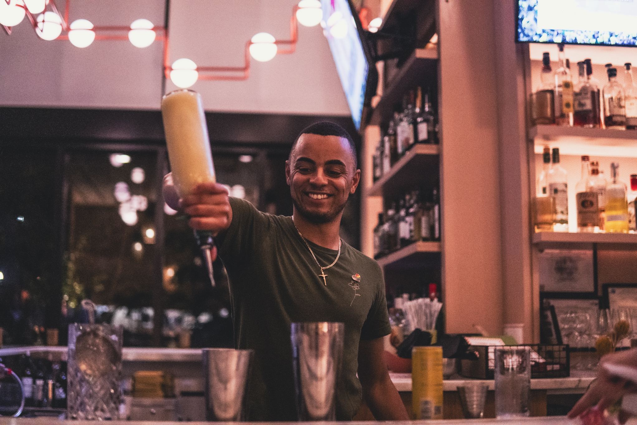 Bartending pouring a drink