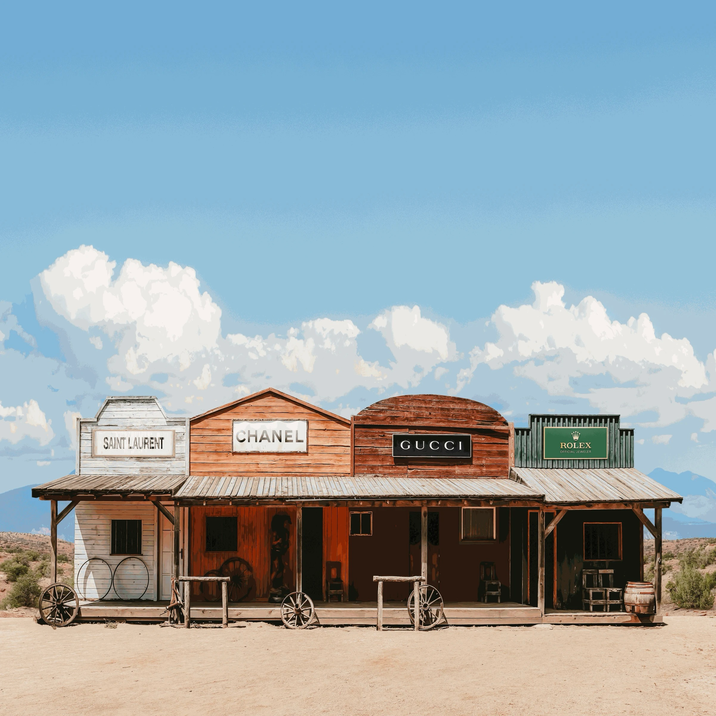 A rustic, wooden western-style storefront with modern brand signs (Saint Laurent, Chanel, Gucci, and Rolex) displayed on top against a clear blue sky.