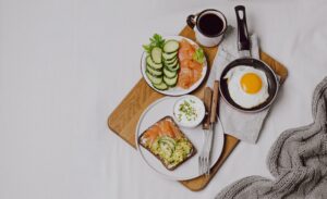 Top view breakfast sandwiches with fried egg and smoked salmon on a bed