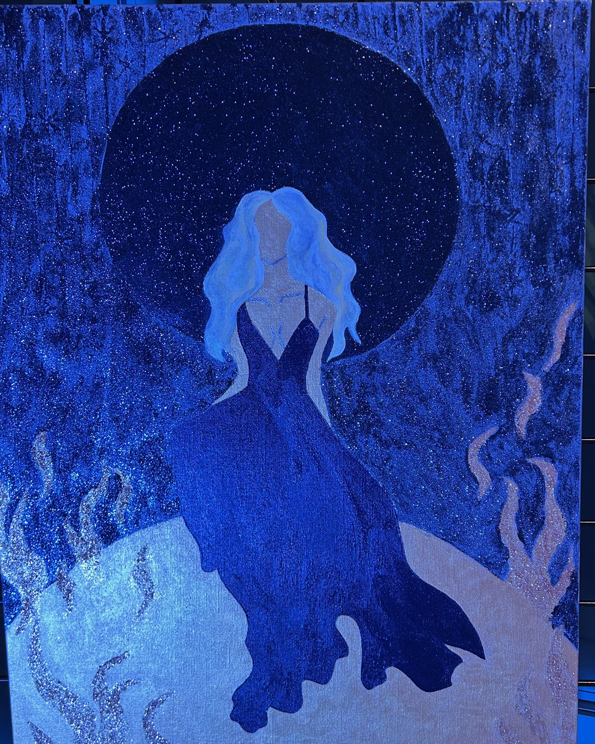 A painting of a faceless woman in a blue dress with flowing white hair, standing under a dark starry sky with abstract swirls in the background.