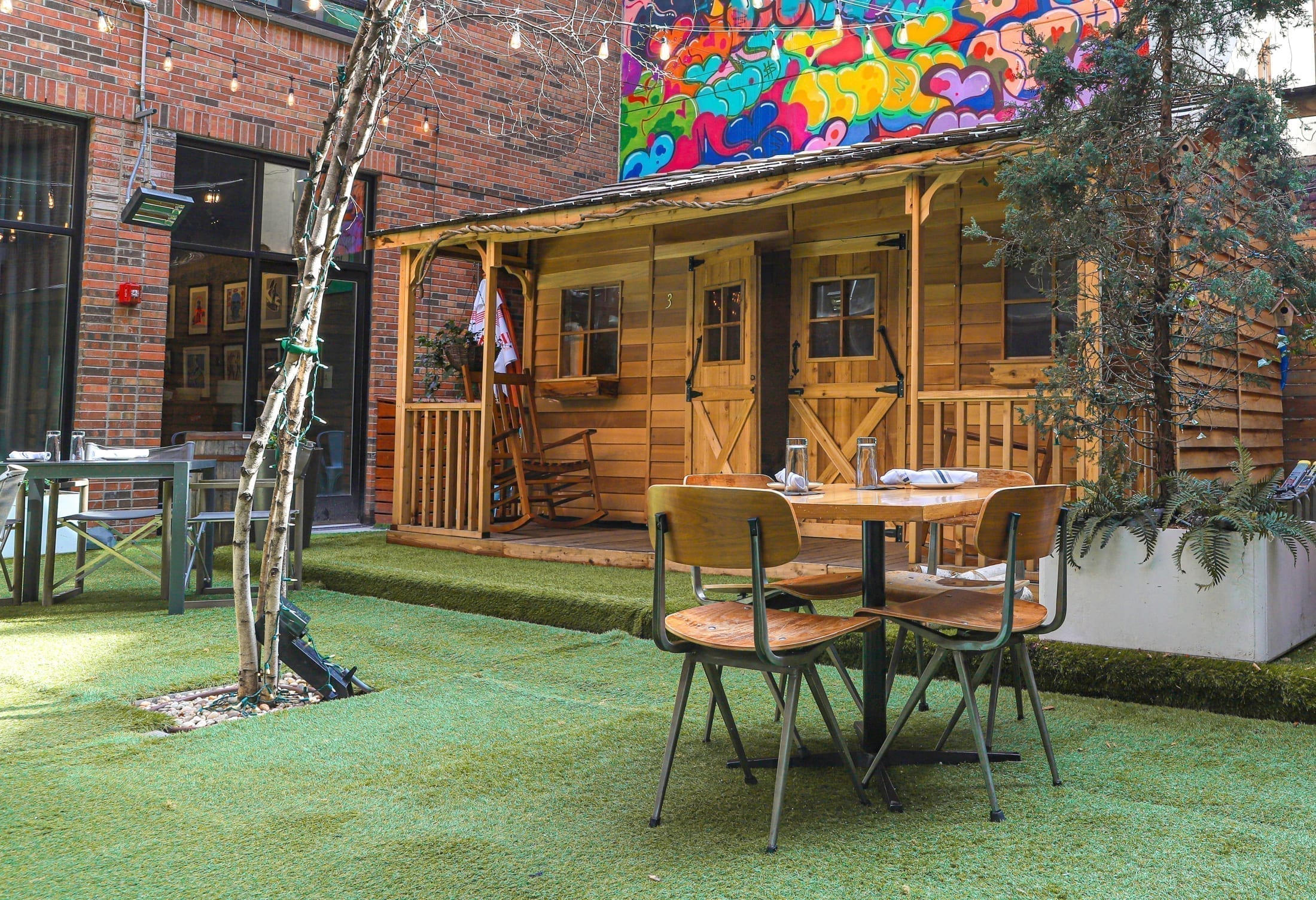 Arlo SoHo Courtyard outdoor seating and covered cabin