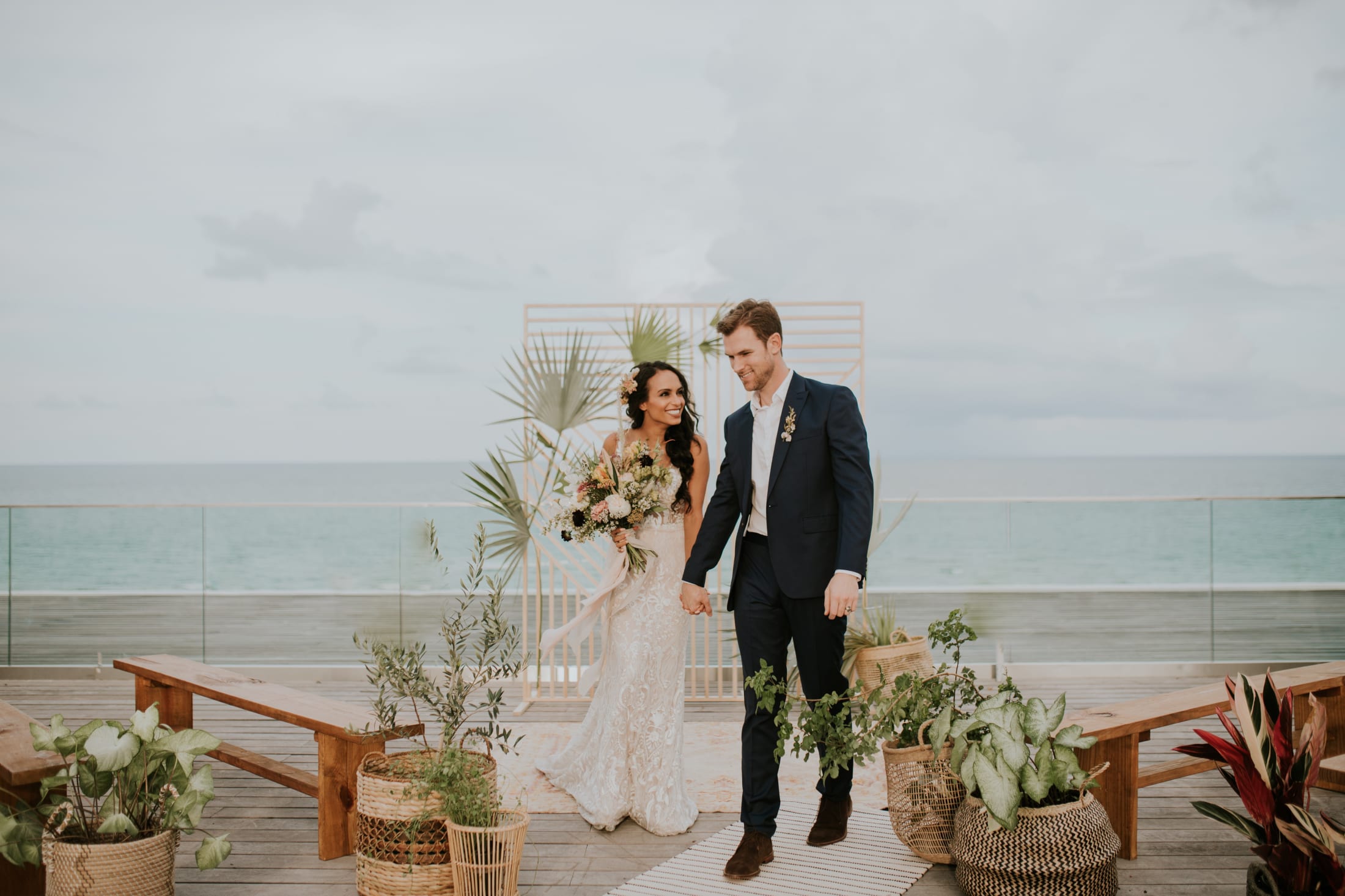 Couple at wedding in front of beach and ocean in background