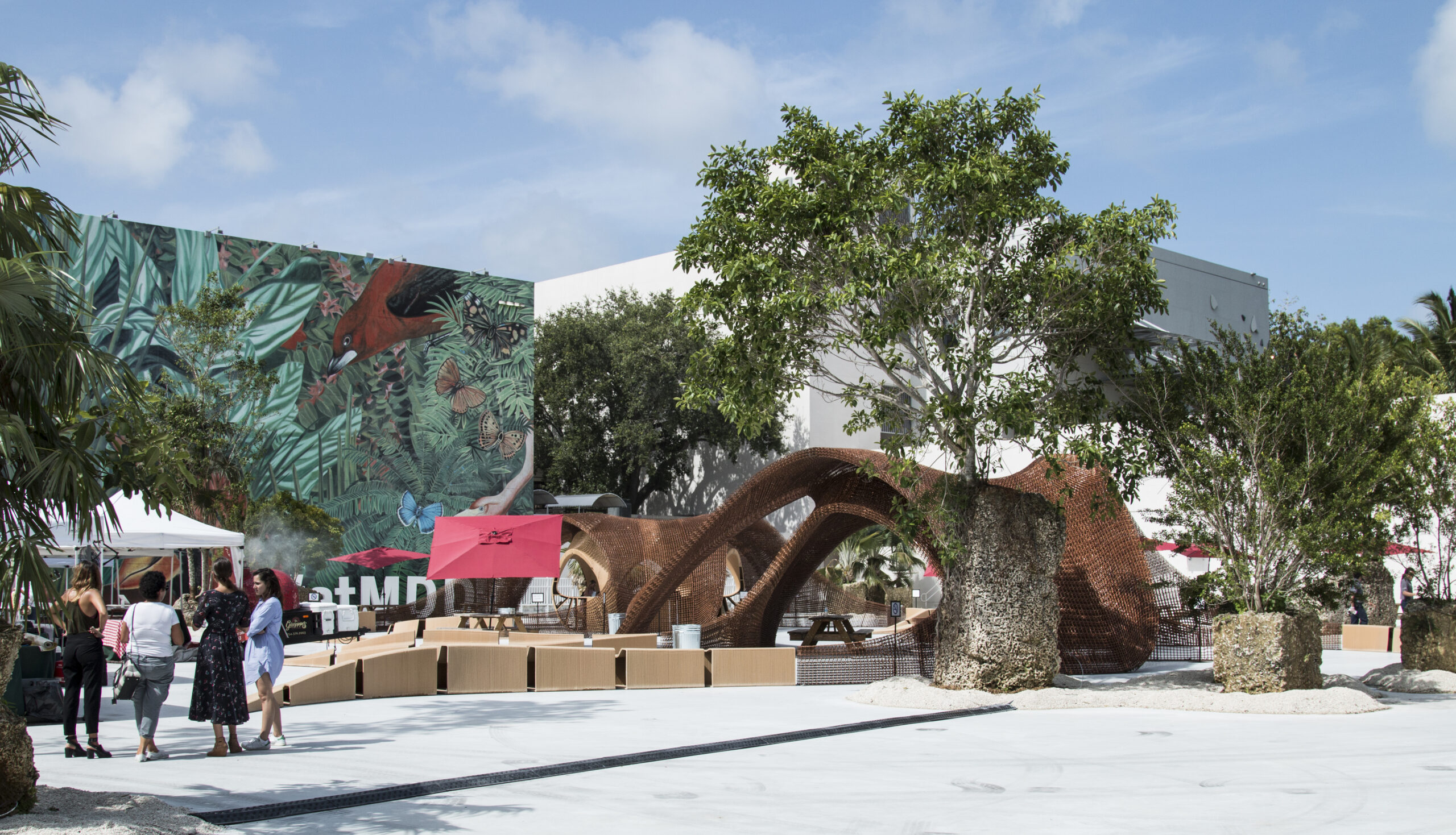 Jungle Plaza in Miami Design District, featuring lush landscaping, colorful public art, and a sculptural outdoor pavilion.